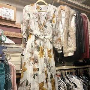 Floral long flowing skirt, has a crisscross neckline and long sleeves.